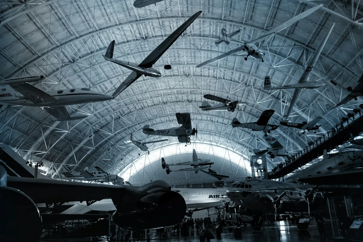 UK aerospace engineer working on aircraft components in a modern hangar setting