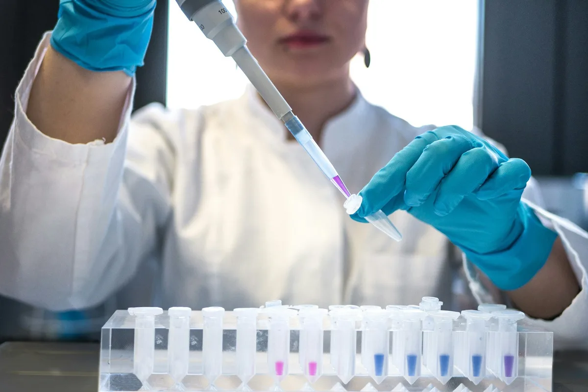 UK biomedical engineer working on a medical device prototype in a lab setting