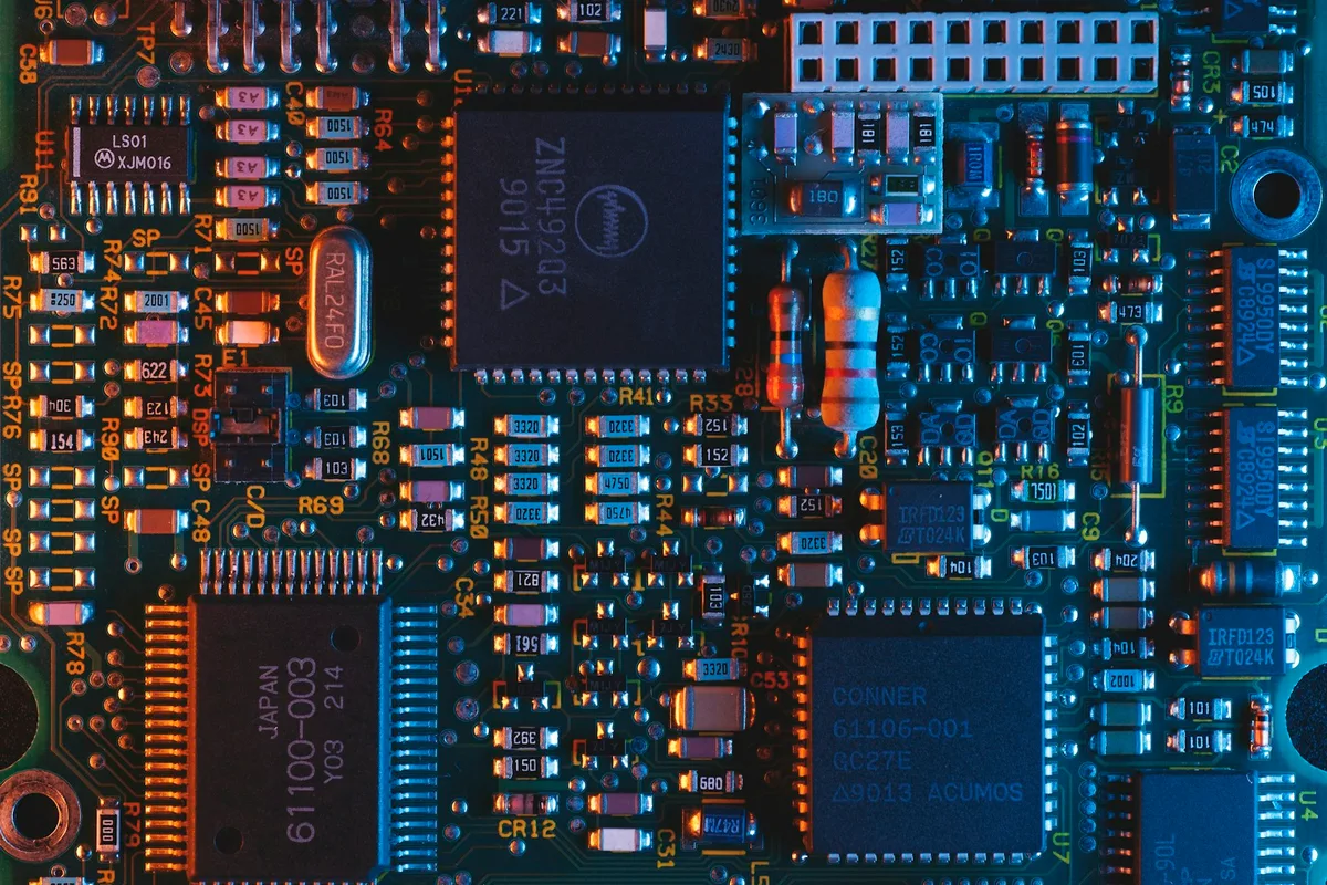 UK electrical engineer examining electronic circuit boards and power systems in a modern lab