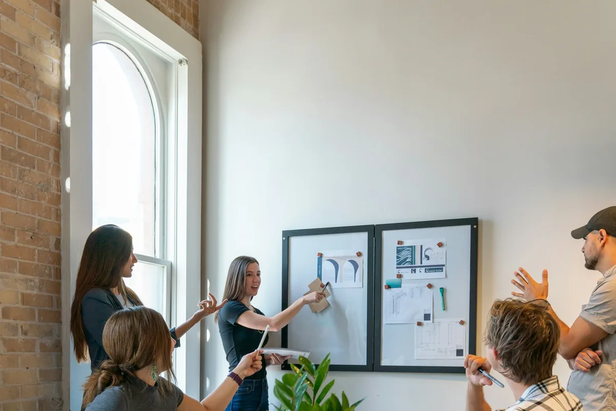 UK HR manager leading a team meeting in a bright modern office