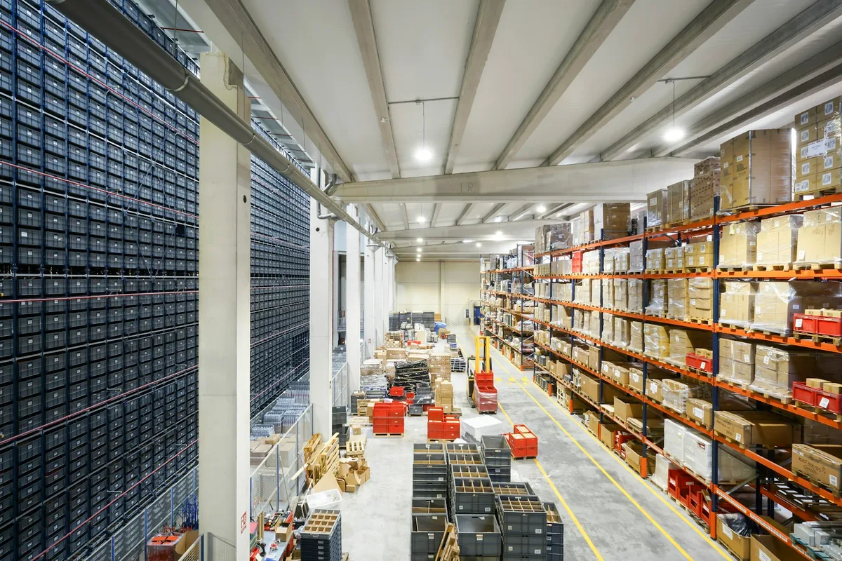 UK logistics manager reviewing warehouse operations and supply-chain dashboards in a modern distribution centre