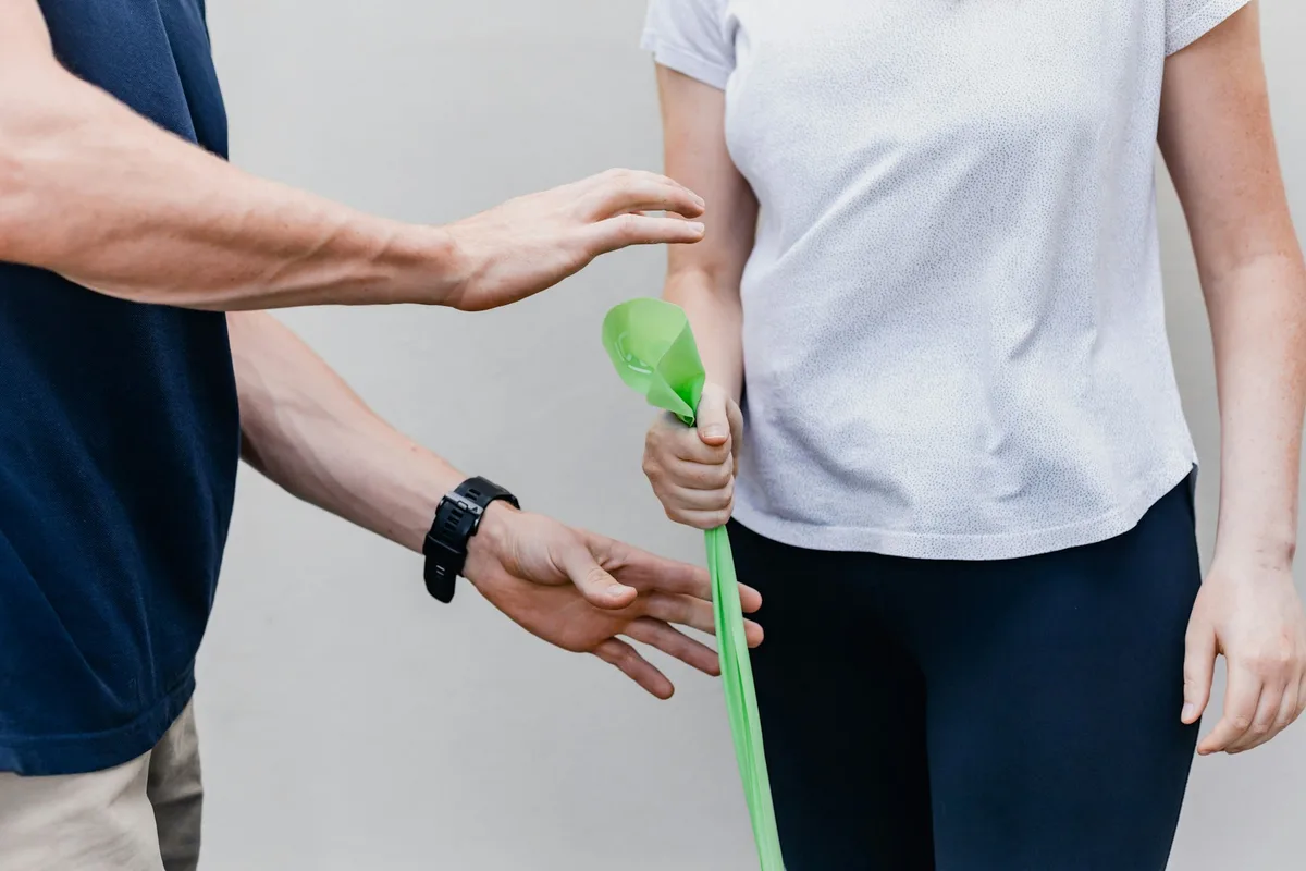 UK occupational therapist supporting a patient with a daily-living rehabilitation activity