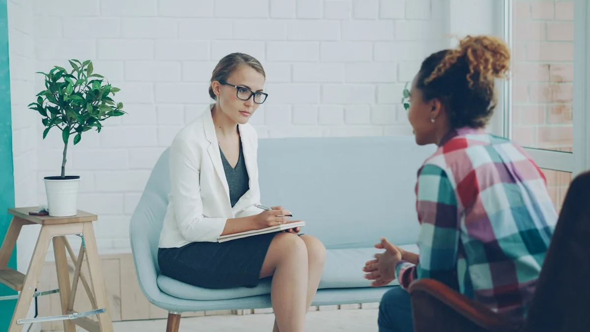 Clinical psychologist in a calm consulting room talking with a client during a one-to-one therapy session
