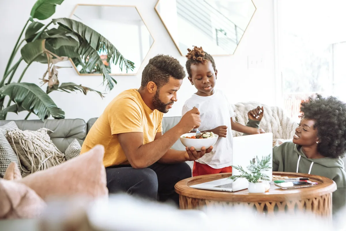 UK social worker in a supportive home-visit meeting with a family