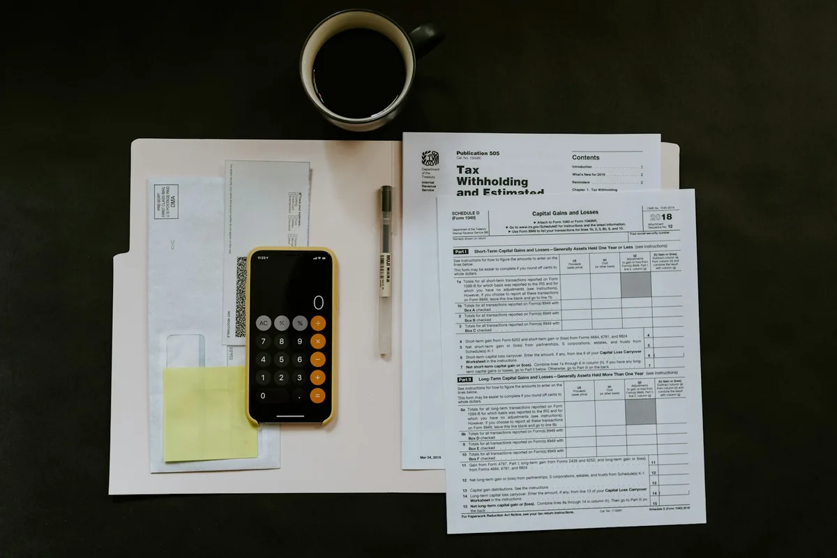UK tax advisor reviewing tax legislation documents and client structures in a modern professional services office