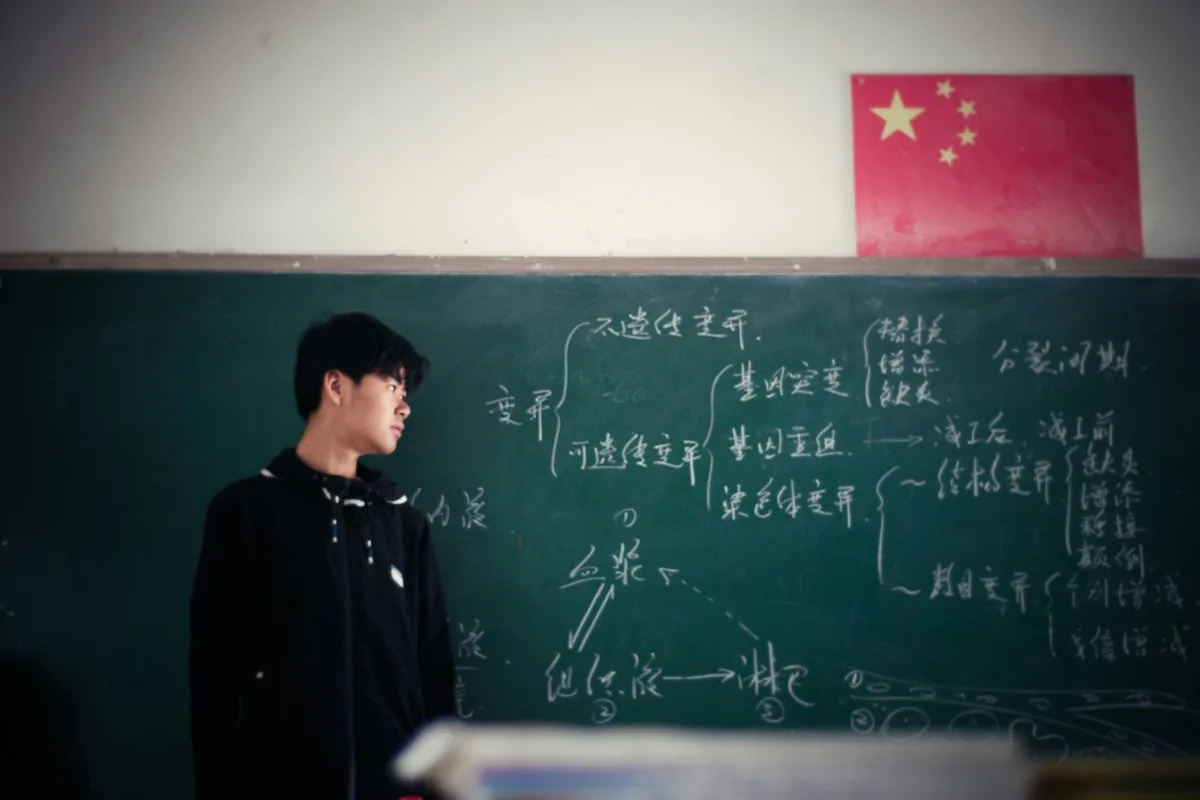 UK teacher in a classroom explaining a topic to engaged secondary school students